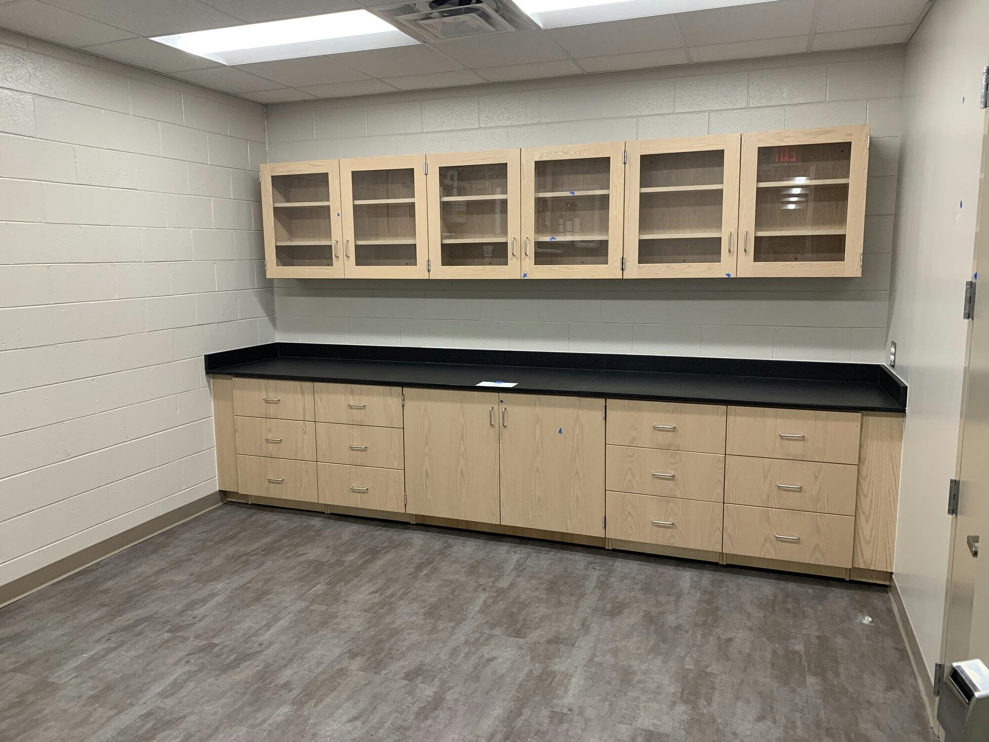 Room with door inside lab classroom offering additional above cabinet space and coutner space.