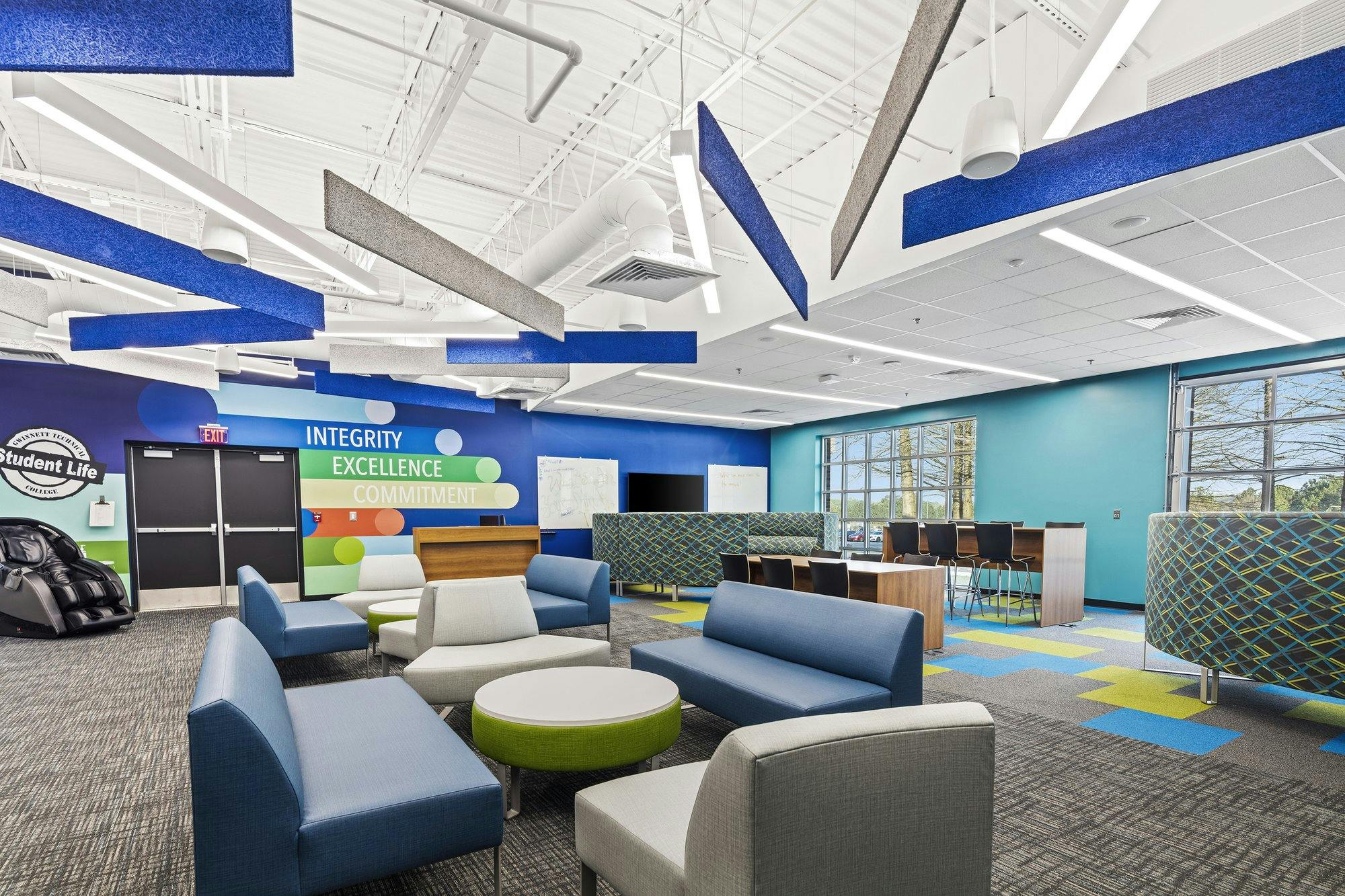 Seating area with couches and round conversation tables.