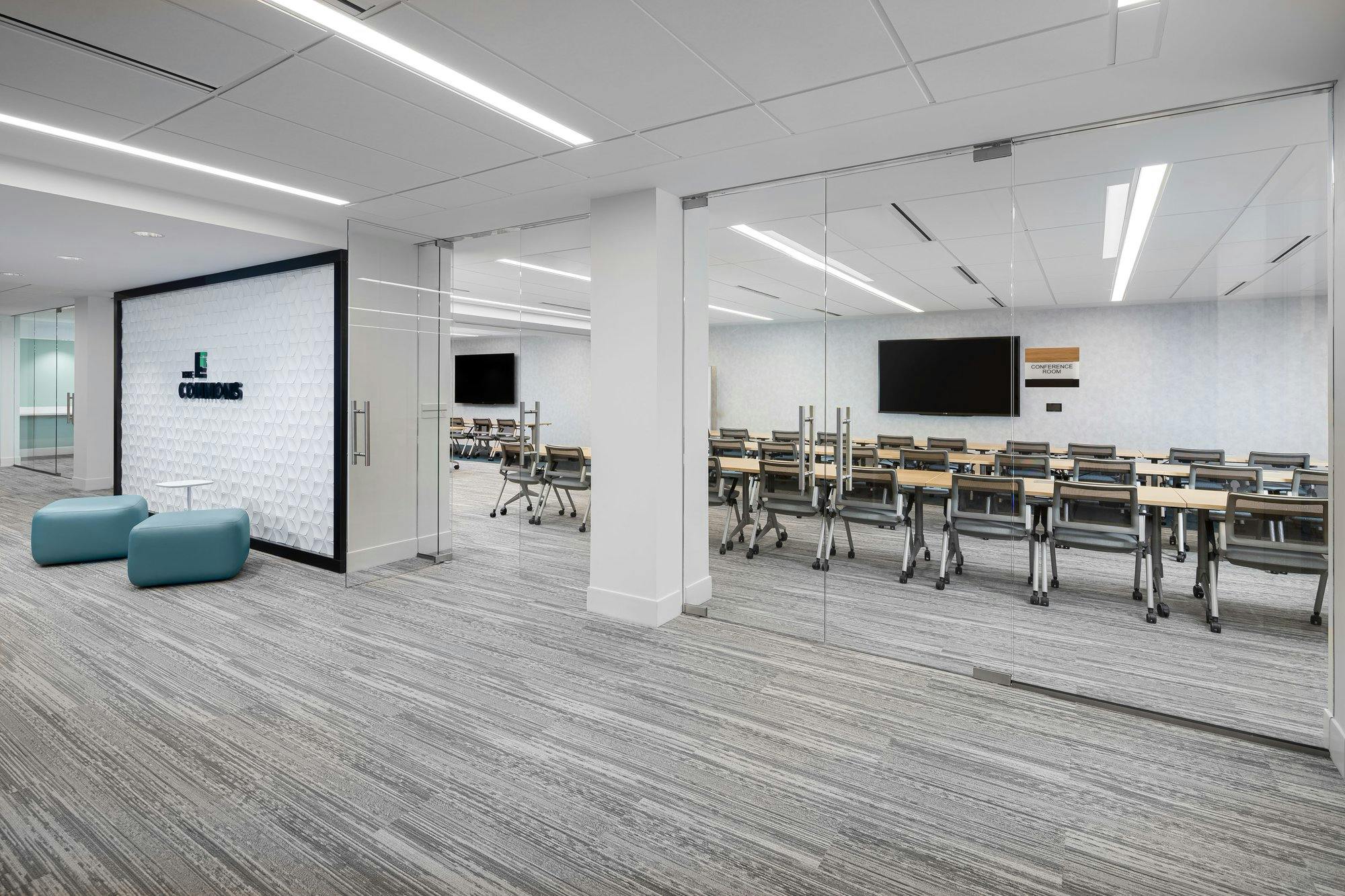 view of a conference room, there are large floor-to-ceiling windows allowing visitors to see the entirety of the space