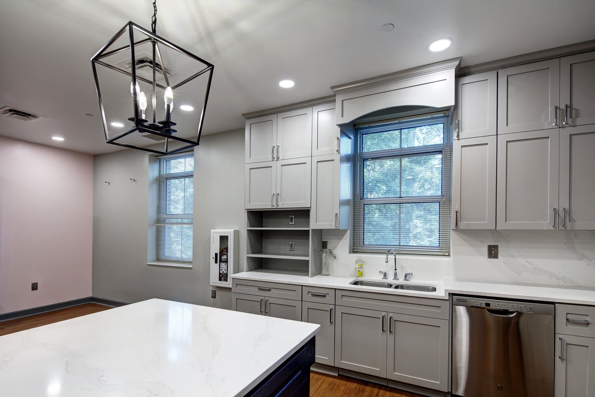 Sorority lodge kitchen area showing window, cabinets, and countertop.