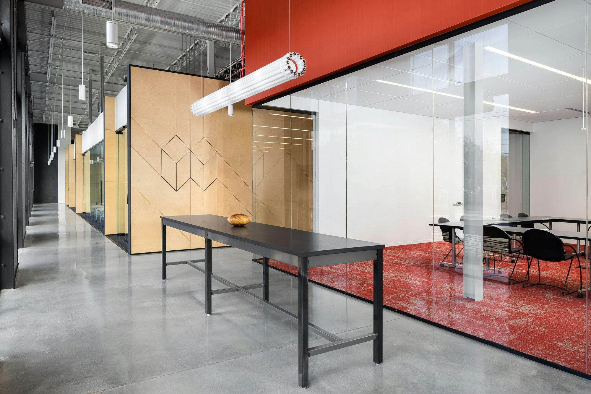 Office space welcome area with table and conference room in the background