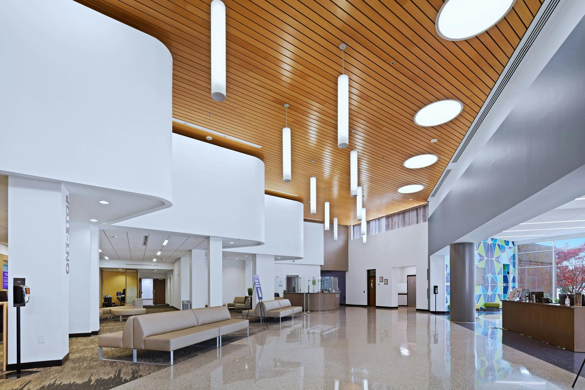 Entryway with modern aesthetic and white lights hanging from ceiling.