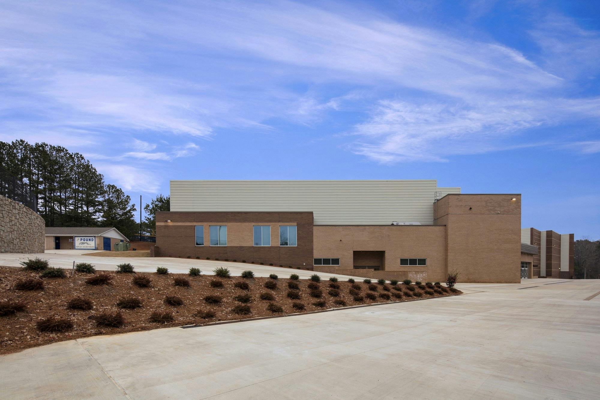 Exterior shot of Pope High School with freshly planted greenery and a concrete driveway.