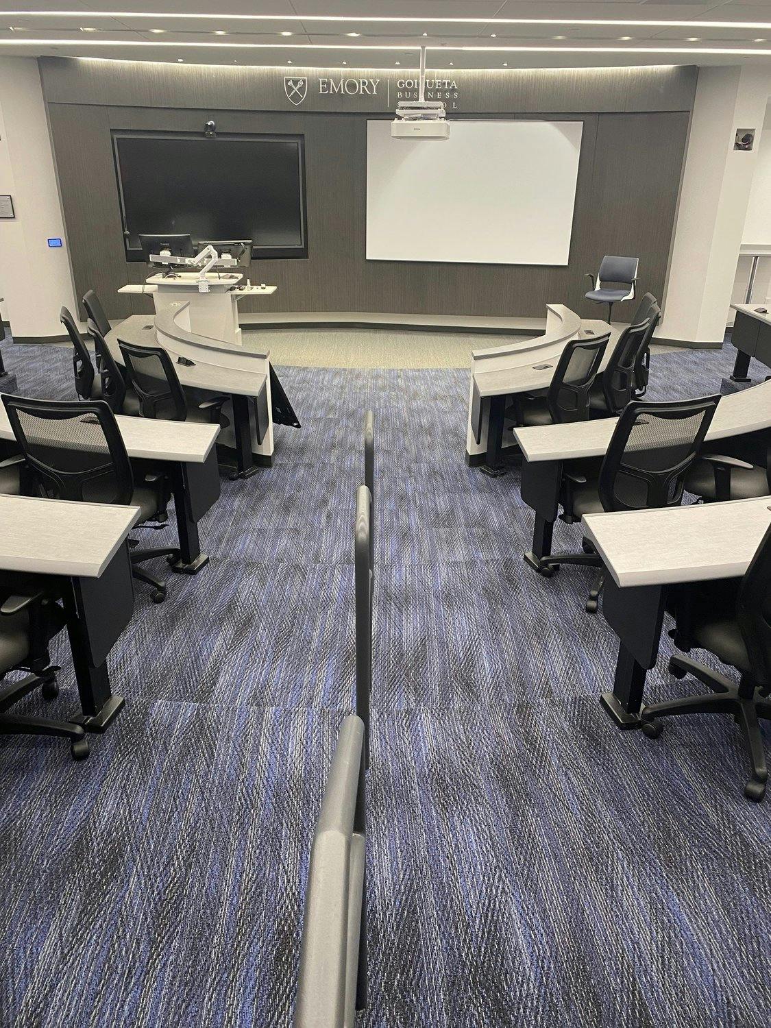 Technical lecture hall classroom with tables and chairs.