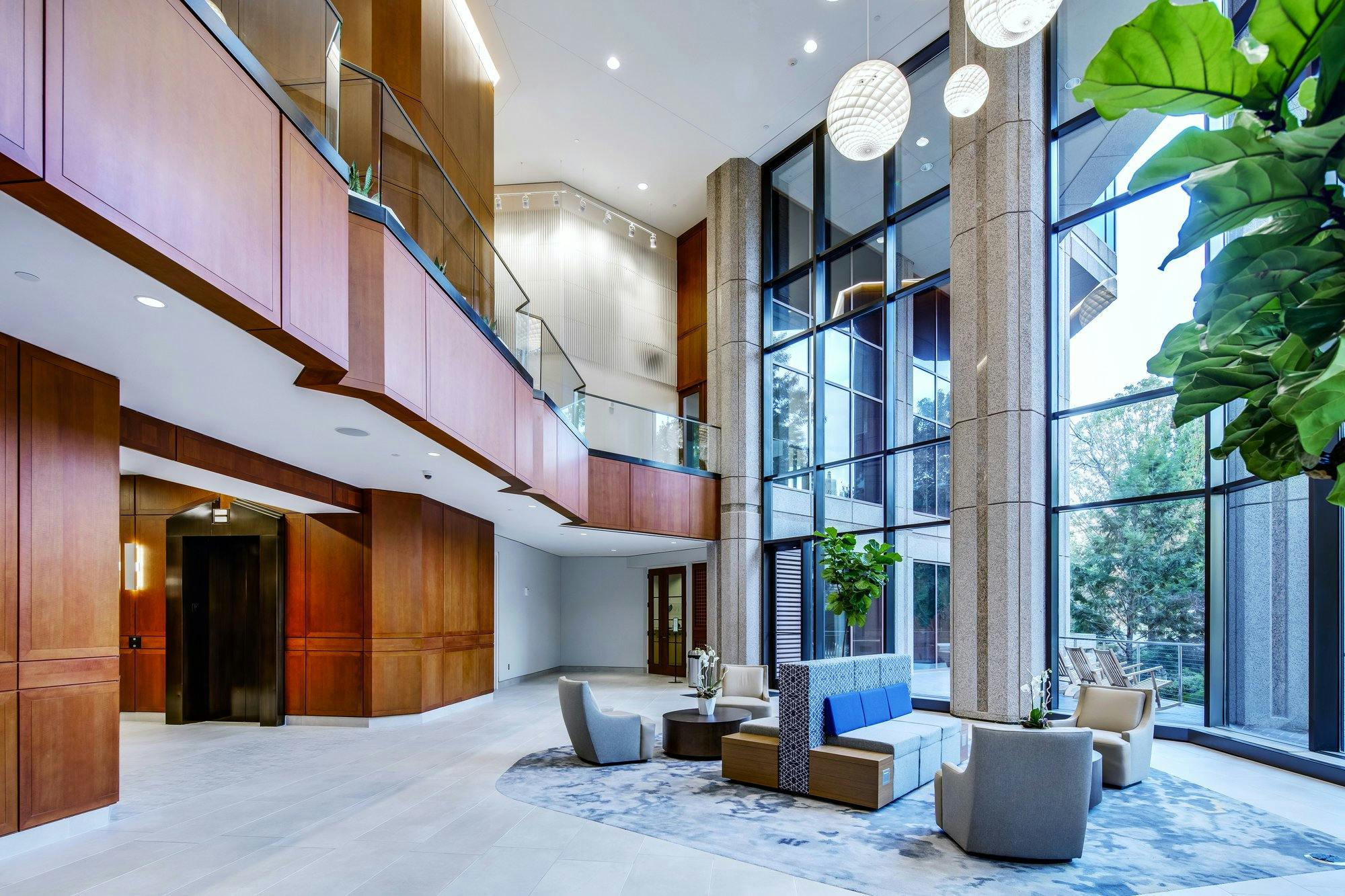 lobby of the piedmont center, featuring a 2-story high ceiling, spherical light fixtures, floor-to-ceiling windows, and a second-floor viewing deck