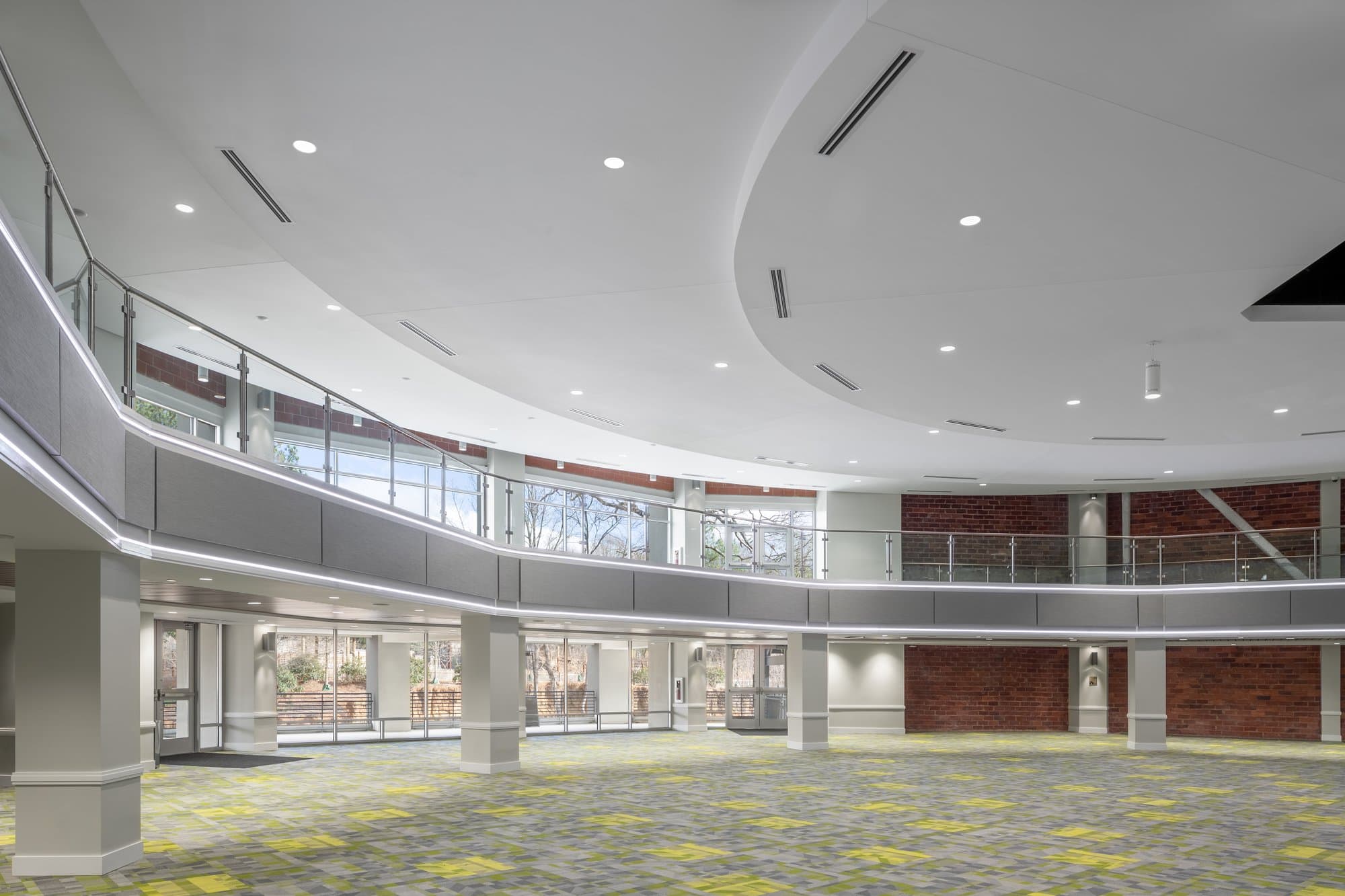 interior of the savanna hall showing the back of the room, a large circular ceiling, a second-floor viewing area, and lots of windows letting in light