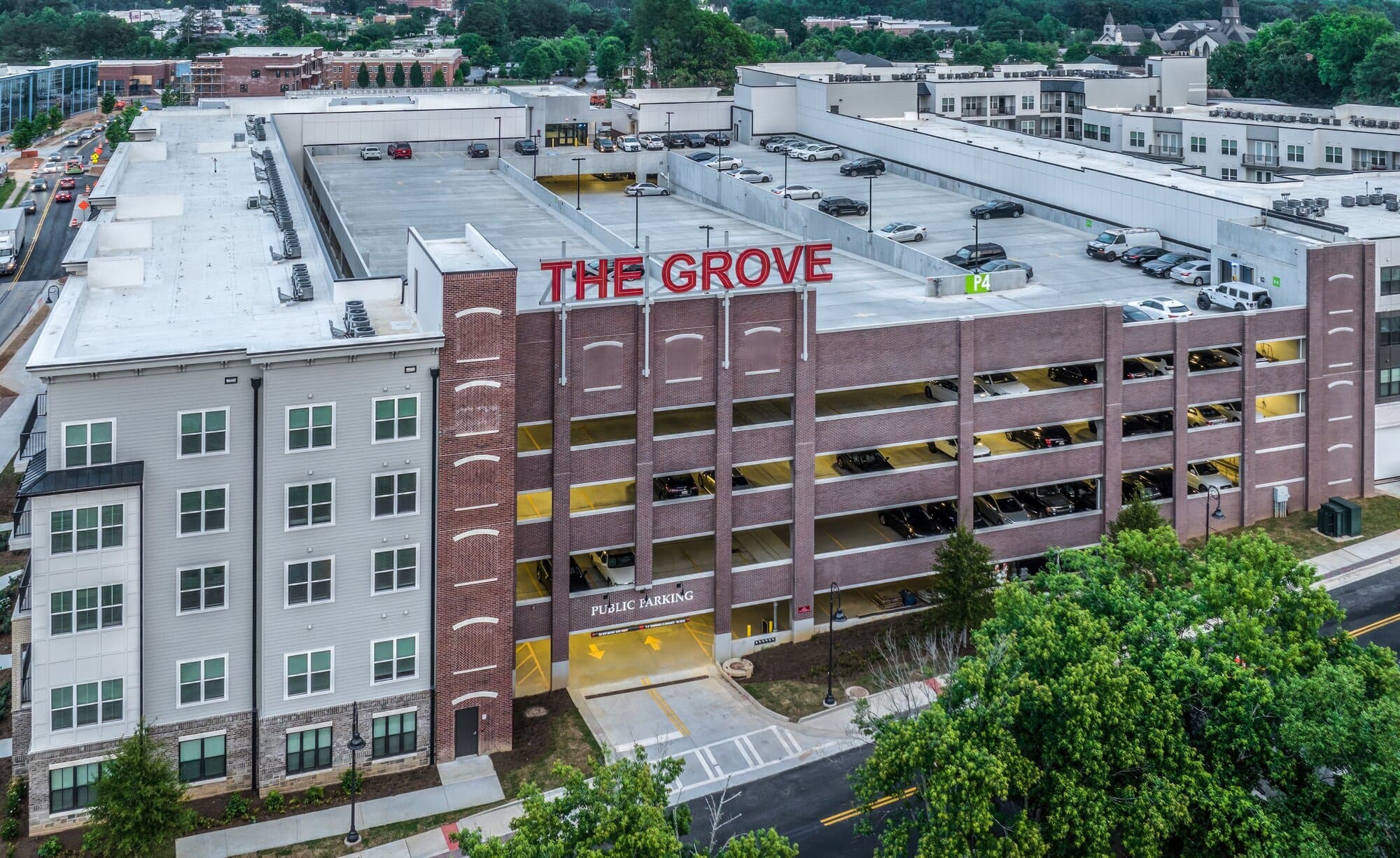 Aerial view of parking garage road entrance. Heavy brick facade.