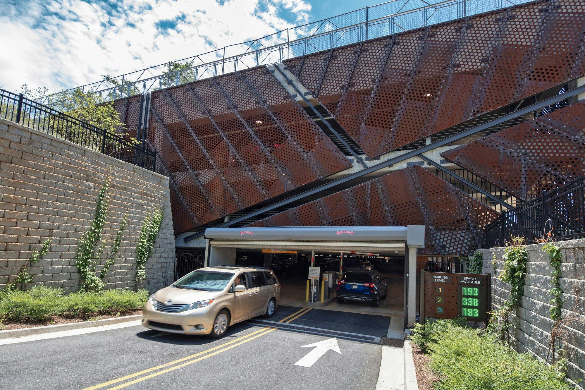 Closeup image of parking deck entryway with car exiting.