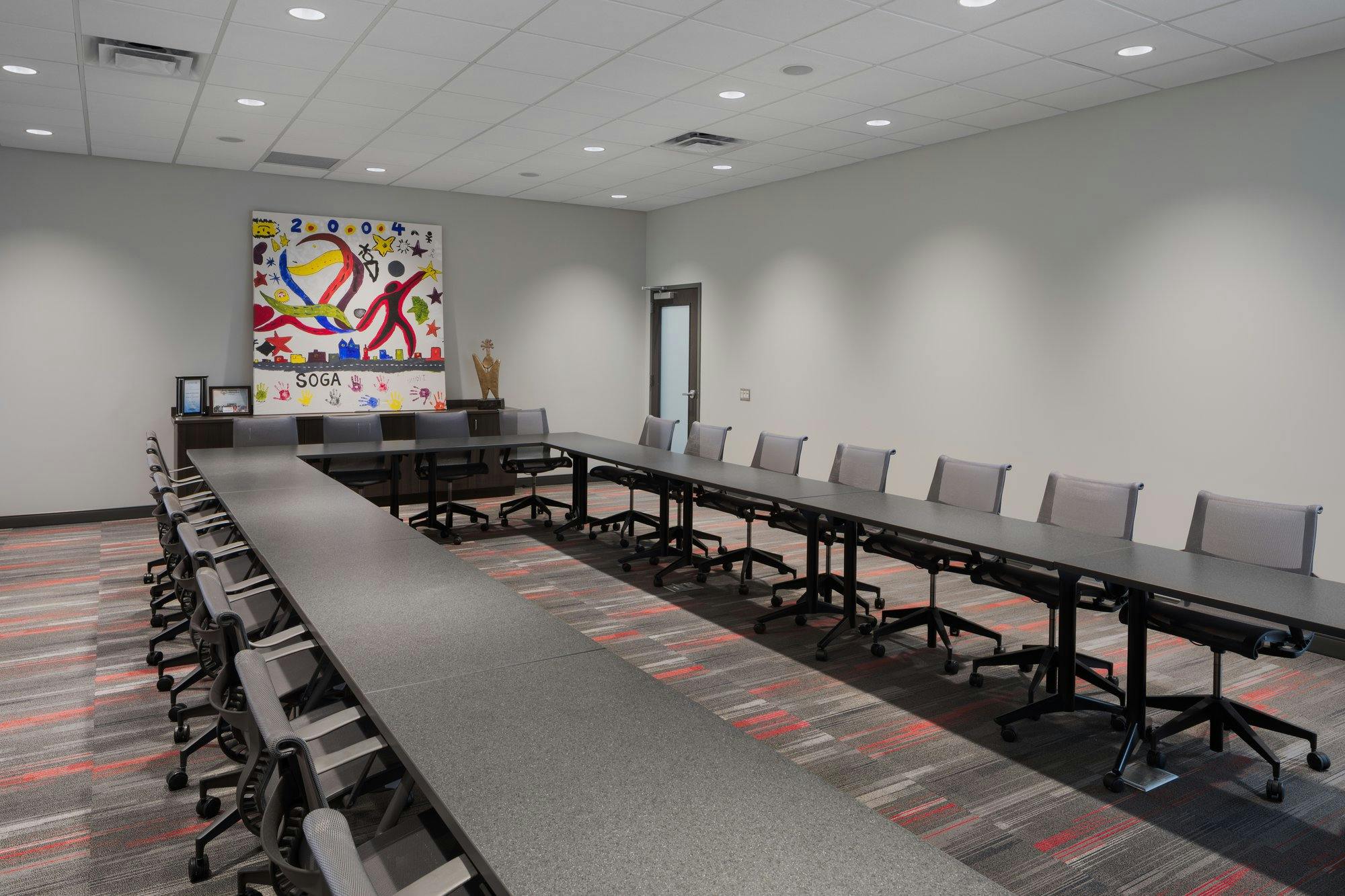 large conference room with tables arranged in a rectangle