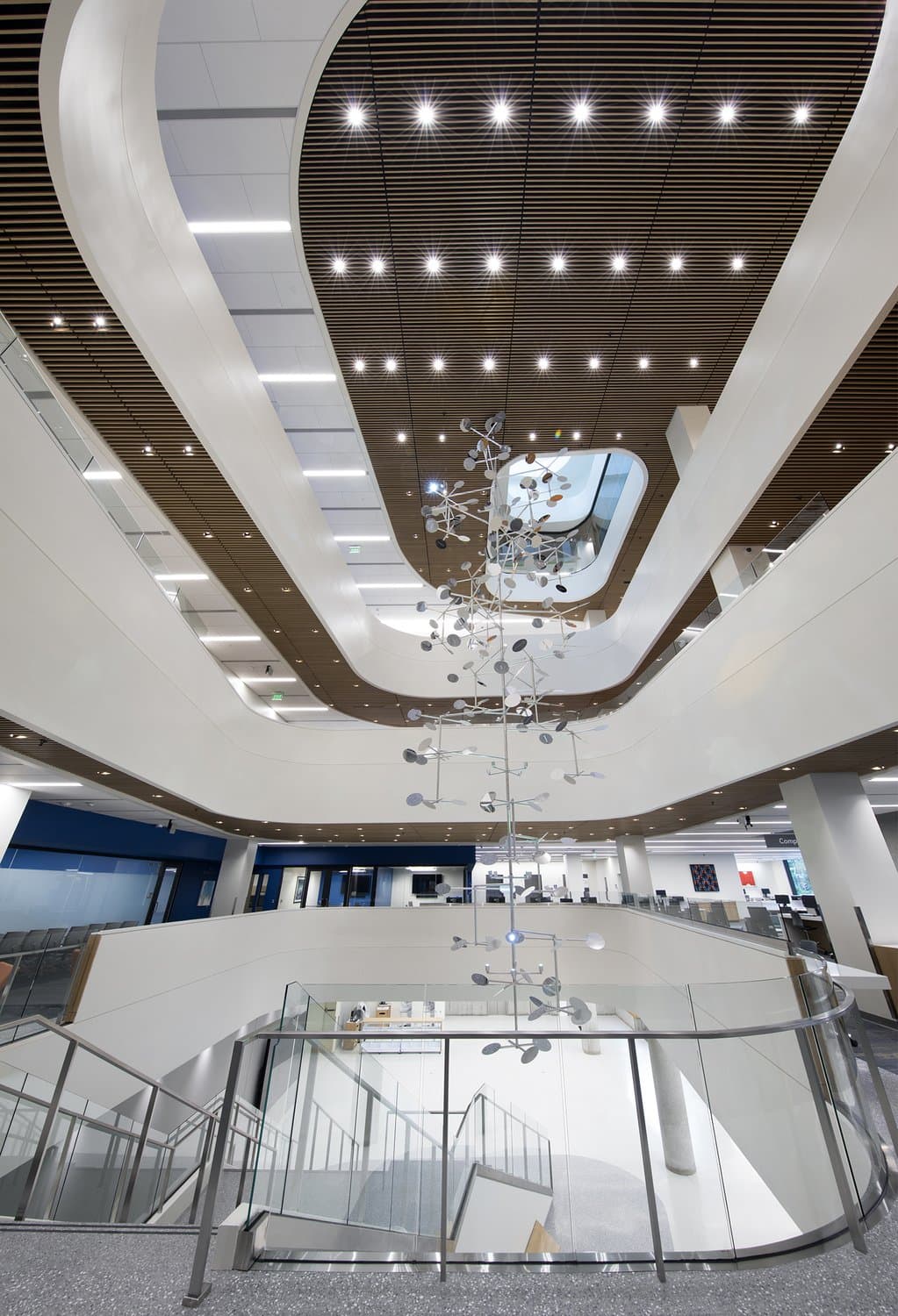 Looking up at a metal chandelier in a library.