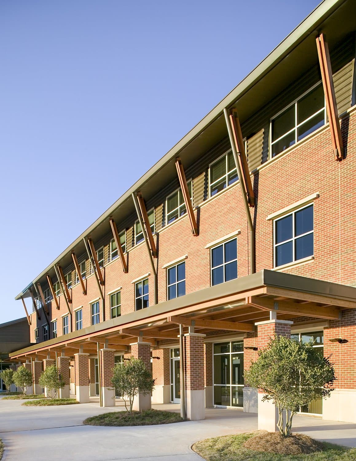 A covered walkway in front of the brick facade of Mt. Vernon Presbyterian School.