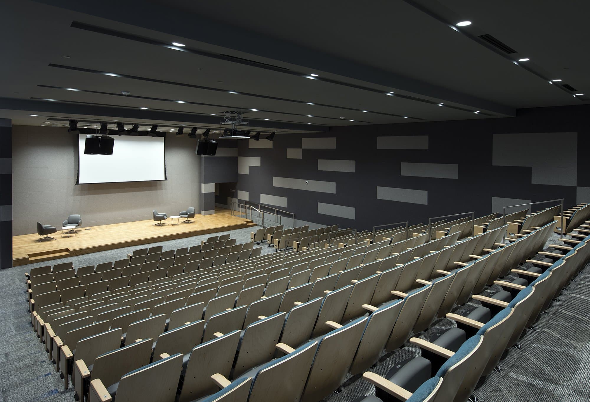 Auditorium with rows of seating looking down towards presentation stage.