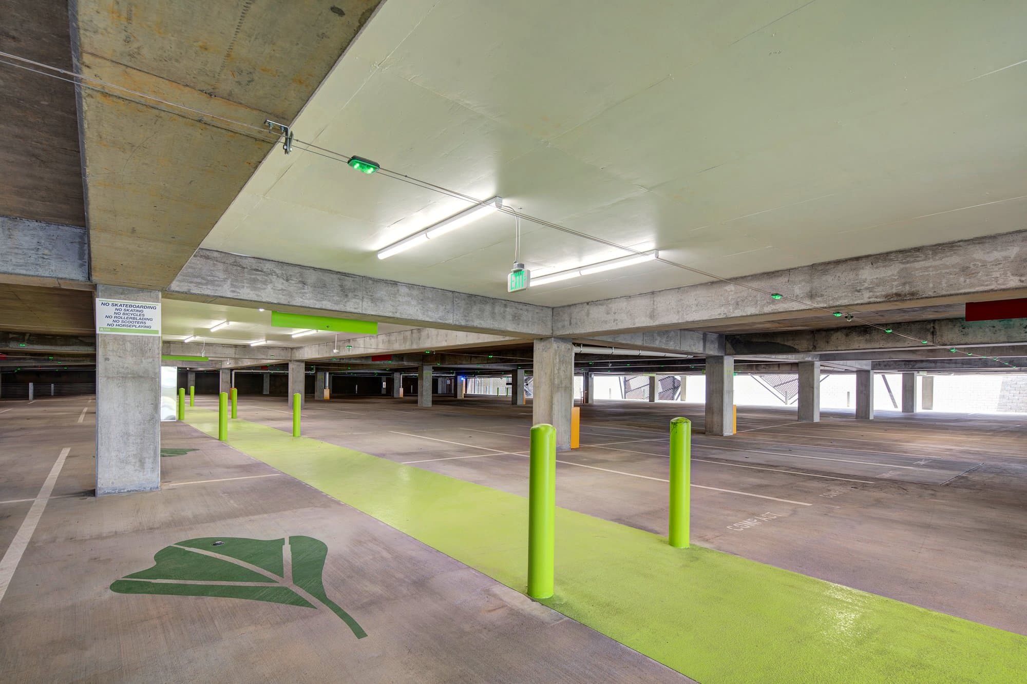 Inside of parking deck with. green crosswalk.