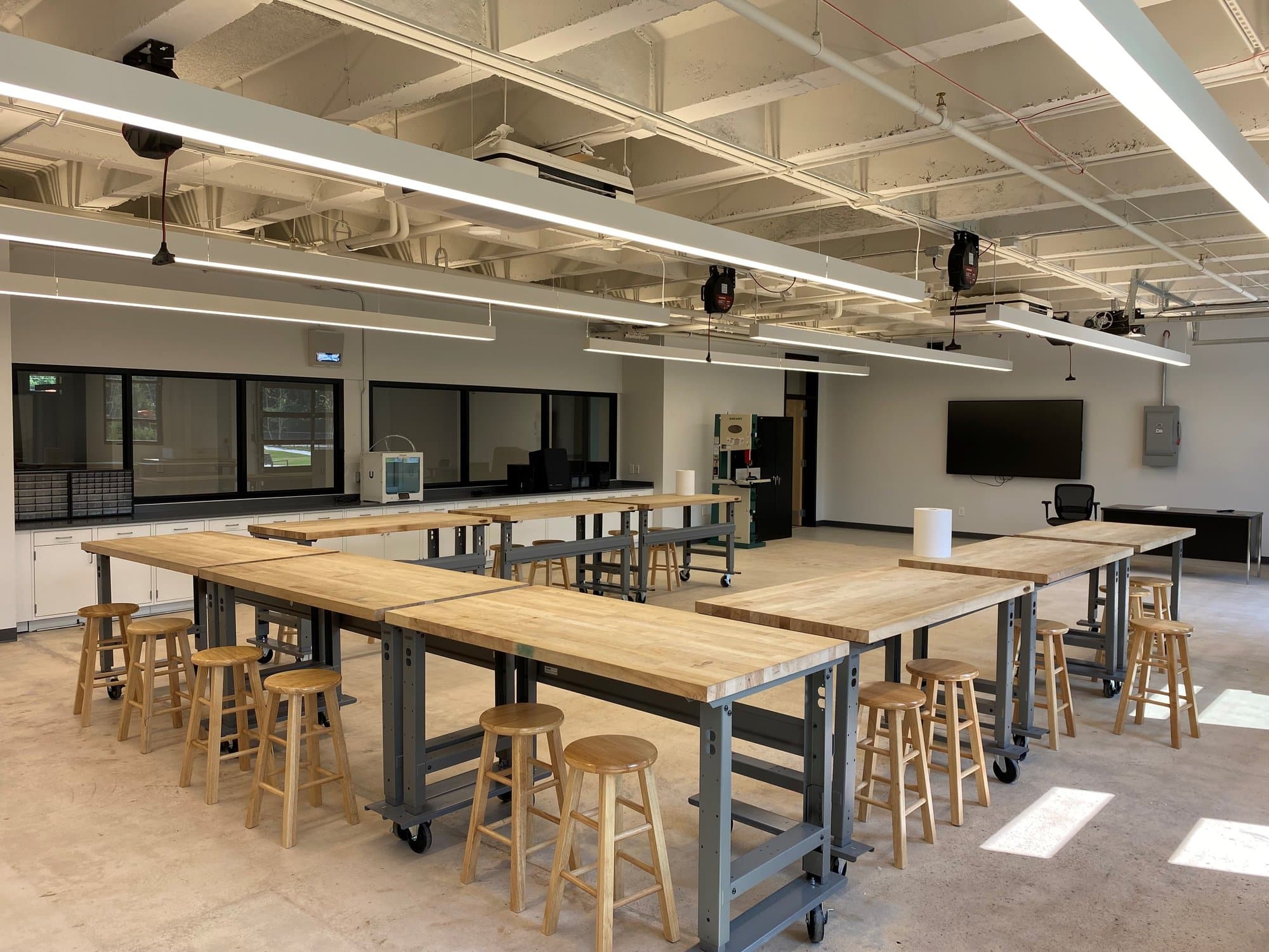 Concrete floors and rigid wood tabletops fill an engineering lab at Landmark Christian School.