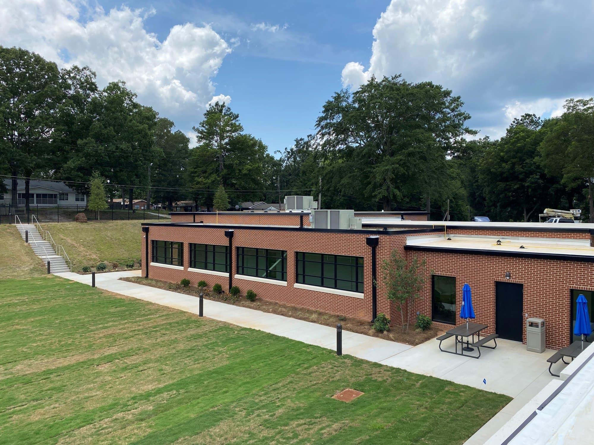 Staircase down a grassy hill leading to the brick exterior facade of Landmark Christian School.